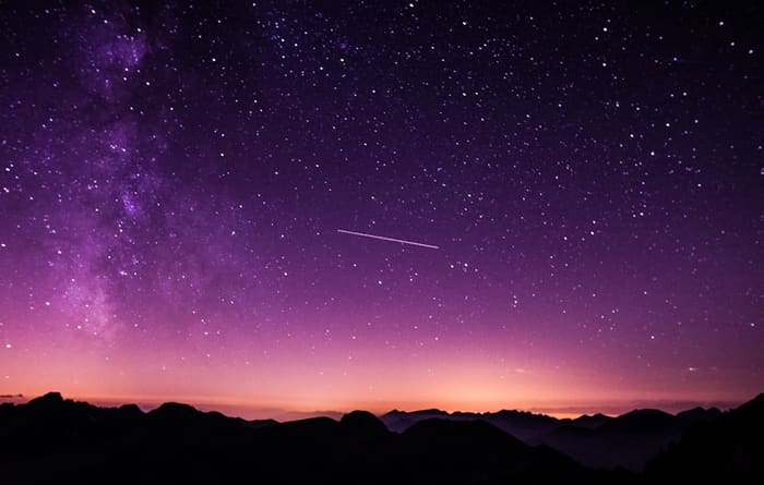 Meteor over mountain peaks poster