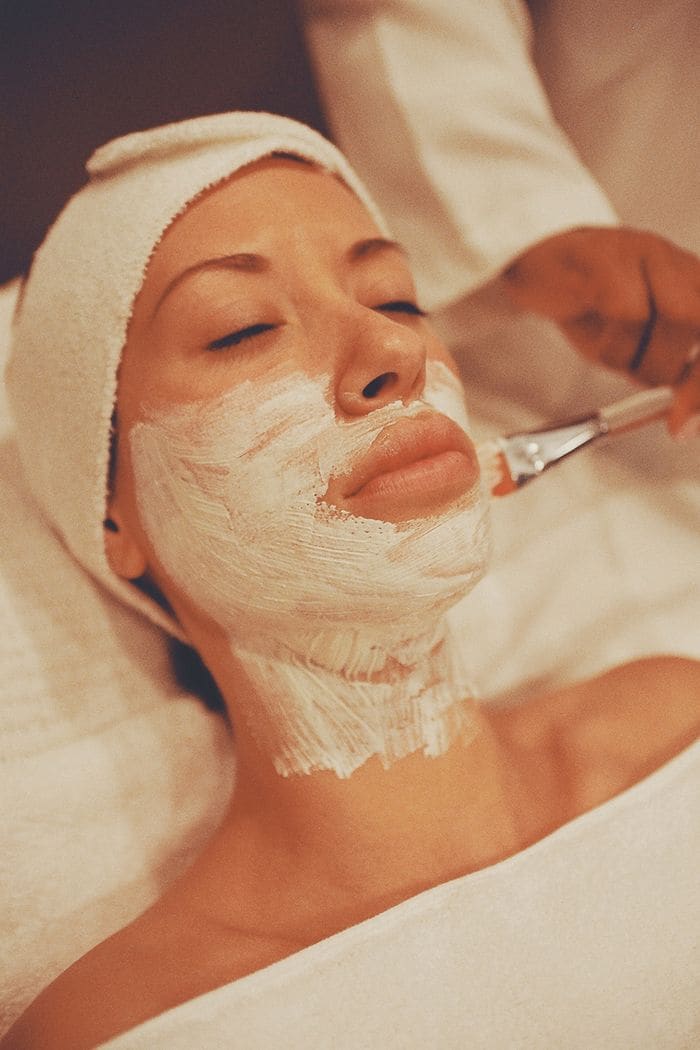A client relaxing during a skincare facial treatment